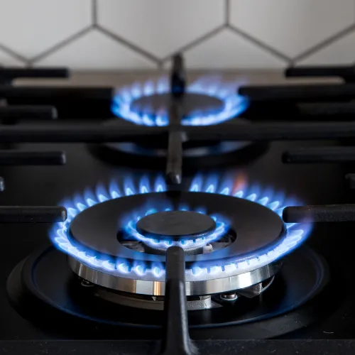 Gas hob burners lit with blue flames